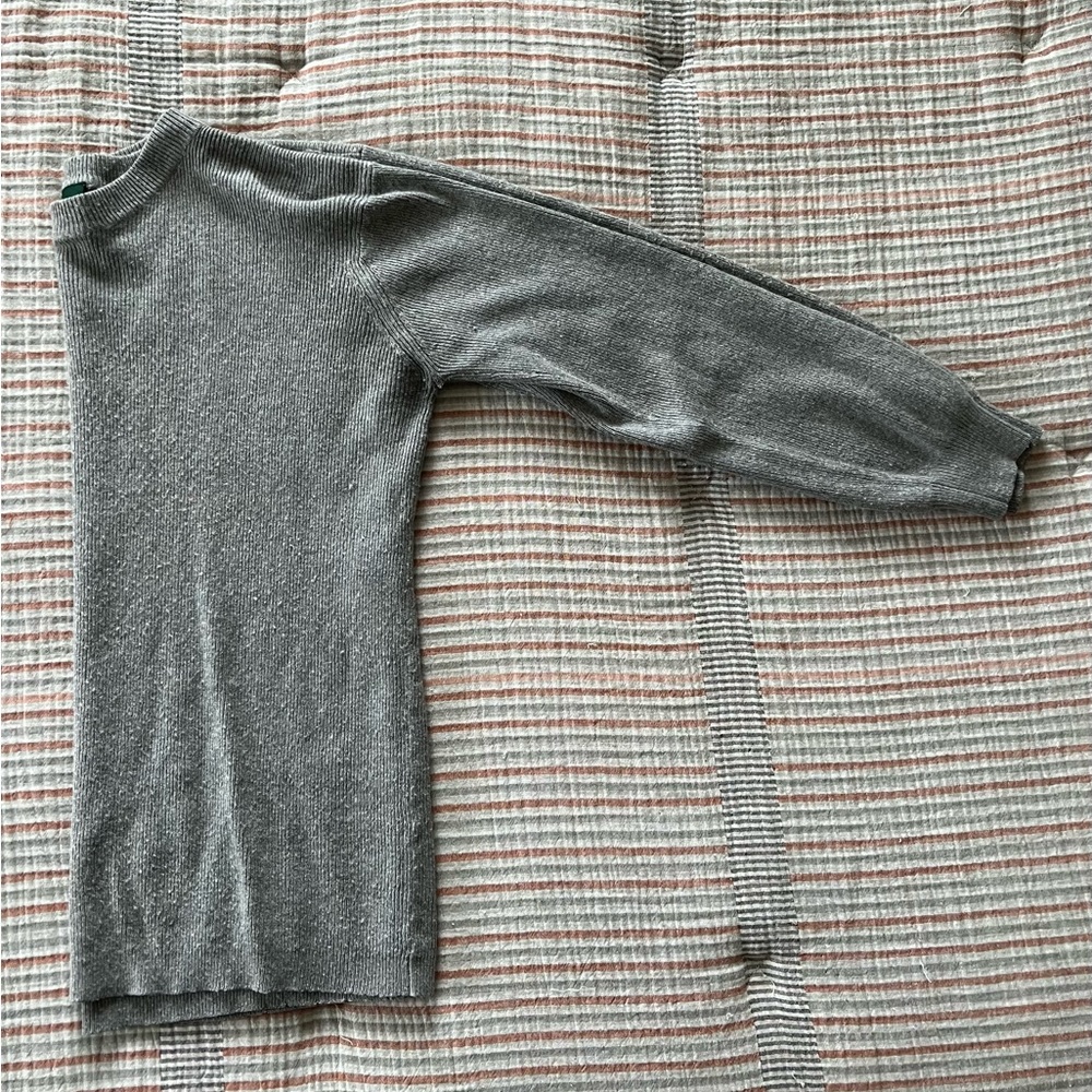 Gray knitted pullover sweater.